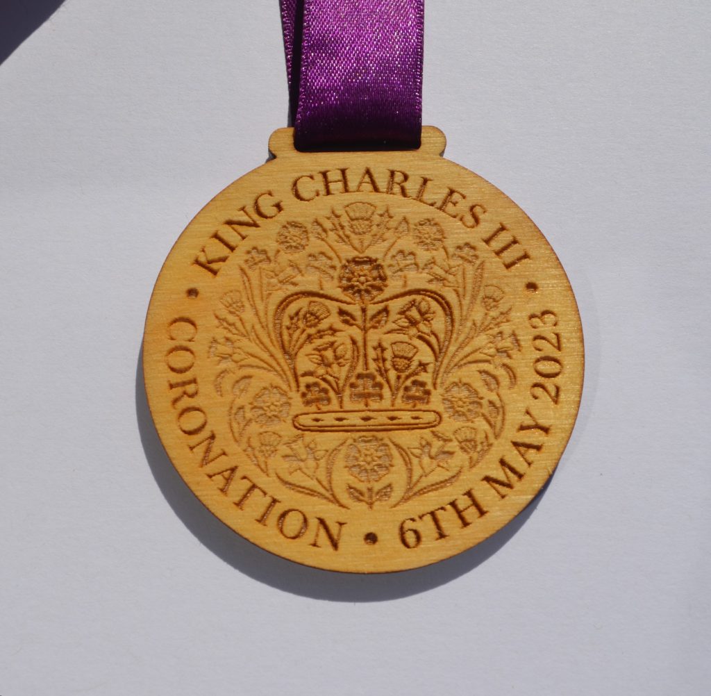 Laser-engraved wooden commemorative medal with ribbon